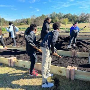 Whale Branch Middle School students fill-in their newly built raised garden beds.