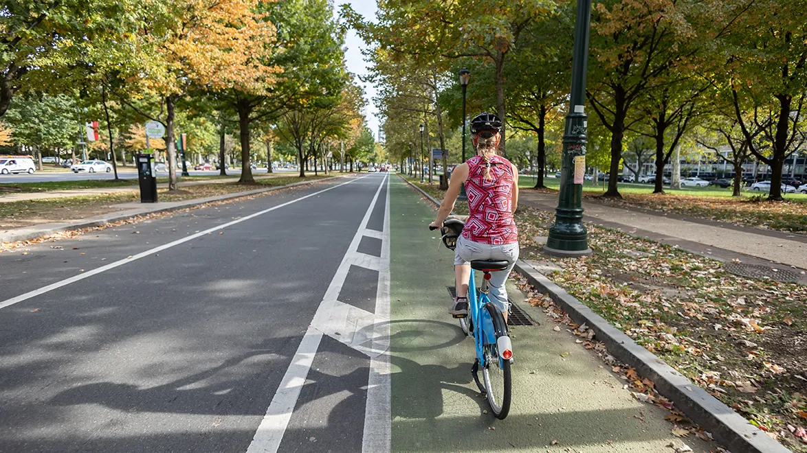 Policy Statement Resource Cyclist using a protected bike lane in a tree-lined urban street